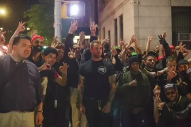 Proud Boys posing for a group photo in the aftermath of their brawl with protesters